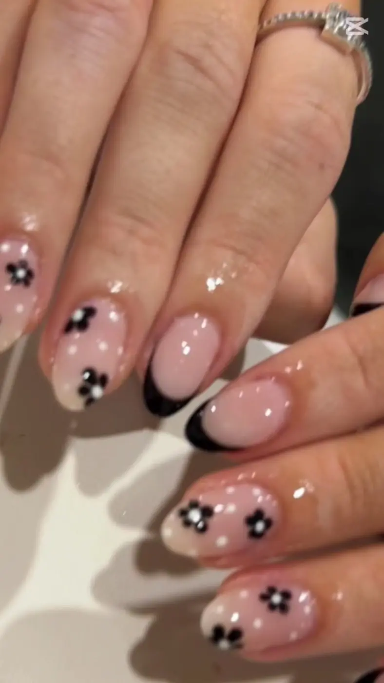 Pink nails with little black flowers and black French tips