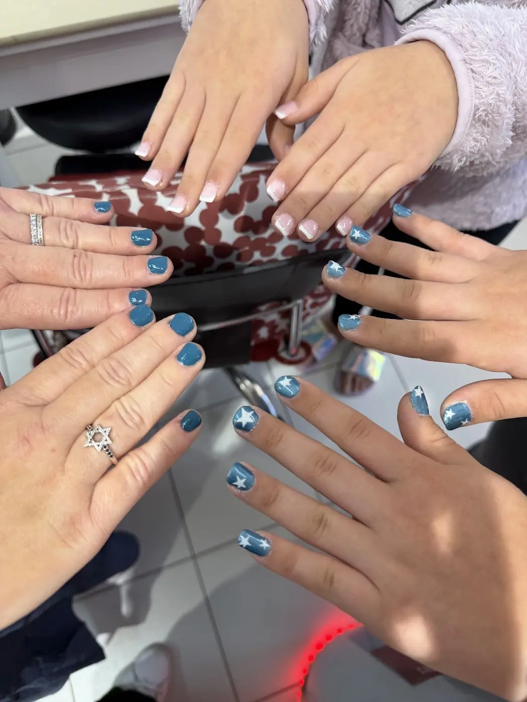 Four friends showing blue and chrome nails